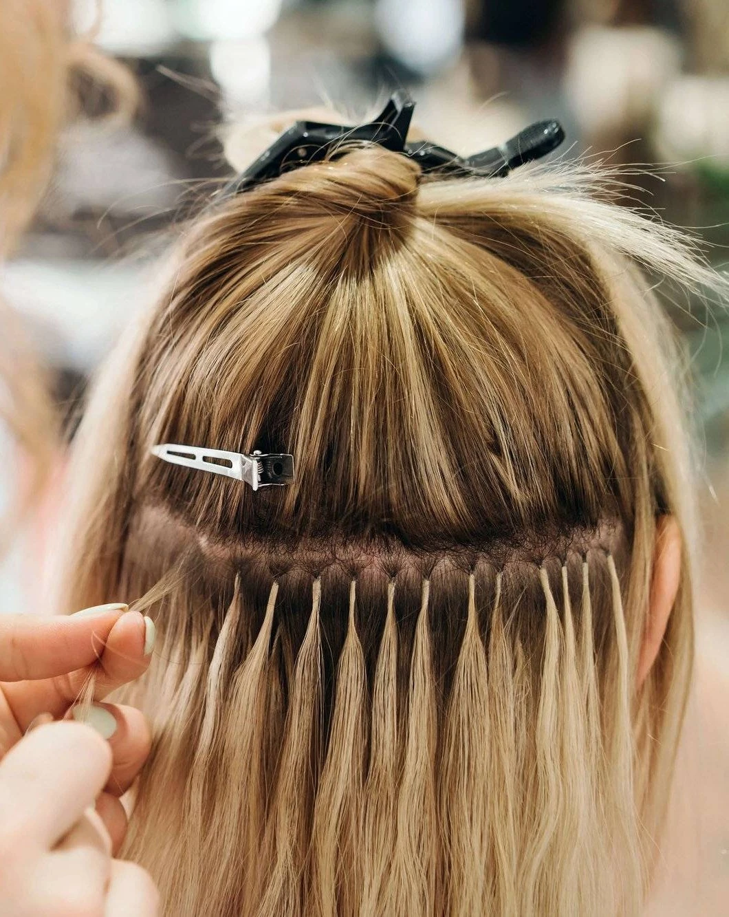 Close-up view of discreet K-tip keratin bond hair extensions at Image London
